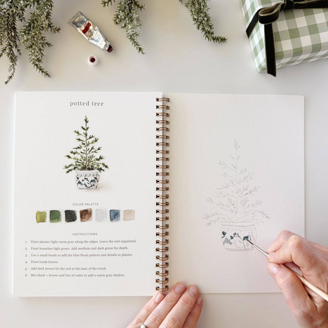Classic Christmas watercolor workbook featuring instruction and practice pages.