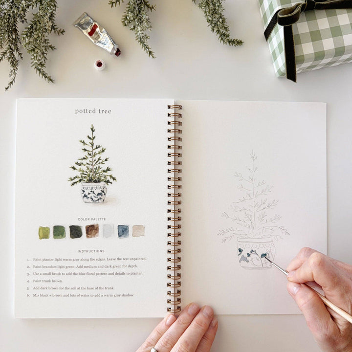 Classic Christmas watercolor workbook featuring instruction and practice pages.