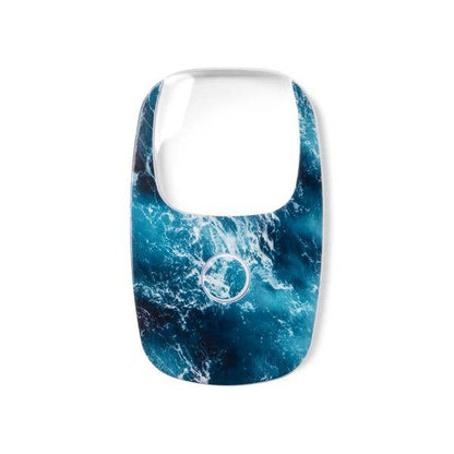 Rectangular OptiCard magnifier cover with blue and white abstract ocean wave pattern, rounded edges, and a central circular opening. Available in sizes for pocket-sized LED magnifiers with 2X magnification.