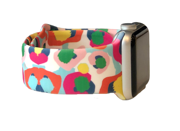 Multicolored cheetah Apple Watch fan 42 to 44 mm. It has white background with pink, green, hot pink , and blue.