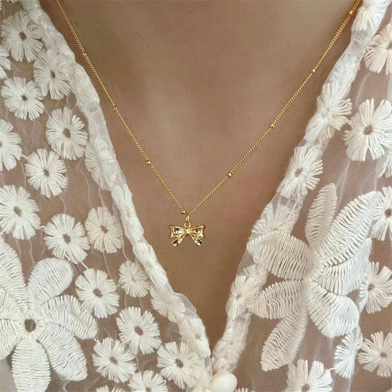 Dainty Bow Tie Bowknot Charm Necklace in 925 Sterling Silver, delicate bowknot design, silver finish. Sizes: 16", 18".