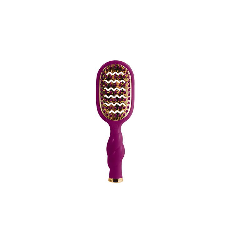 The Mini Vented Hair Brush - Mulberry has a purple body, gold accents, and a vented, curved design. Available in mini size.