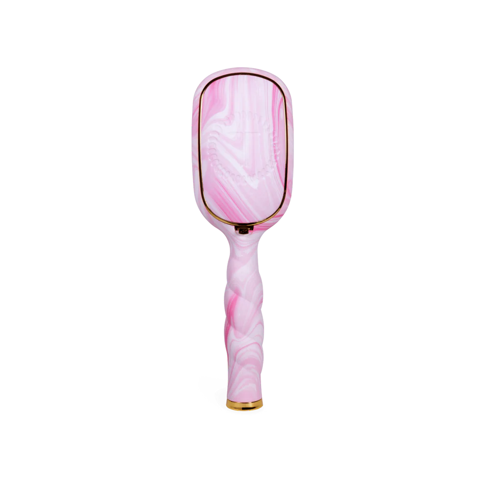 The Pinch Me! Tie Dye Pink Boar Bristle Hair Brush has a marbled pink-white design, gold accents, twisted handle. Sizes: standard.