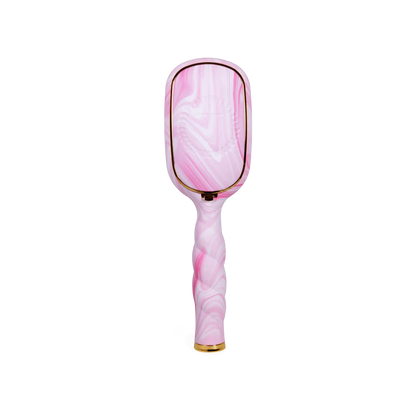 The Pinch Me! Tie Dye Pink Boar Bristle Hair Brush has a marbled pink-white design, gold accents, twisted handle. Sizes: standard.