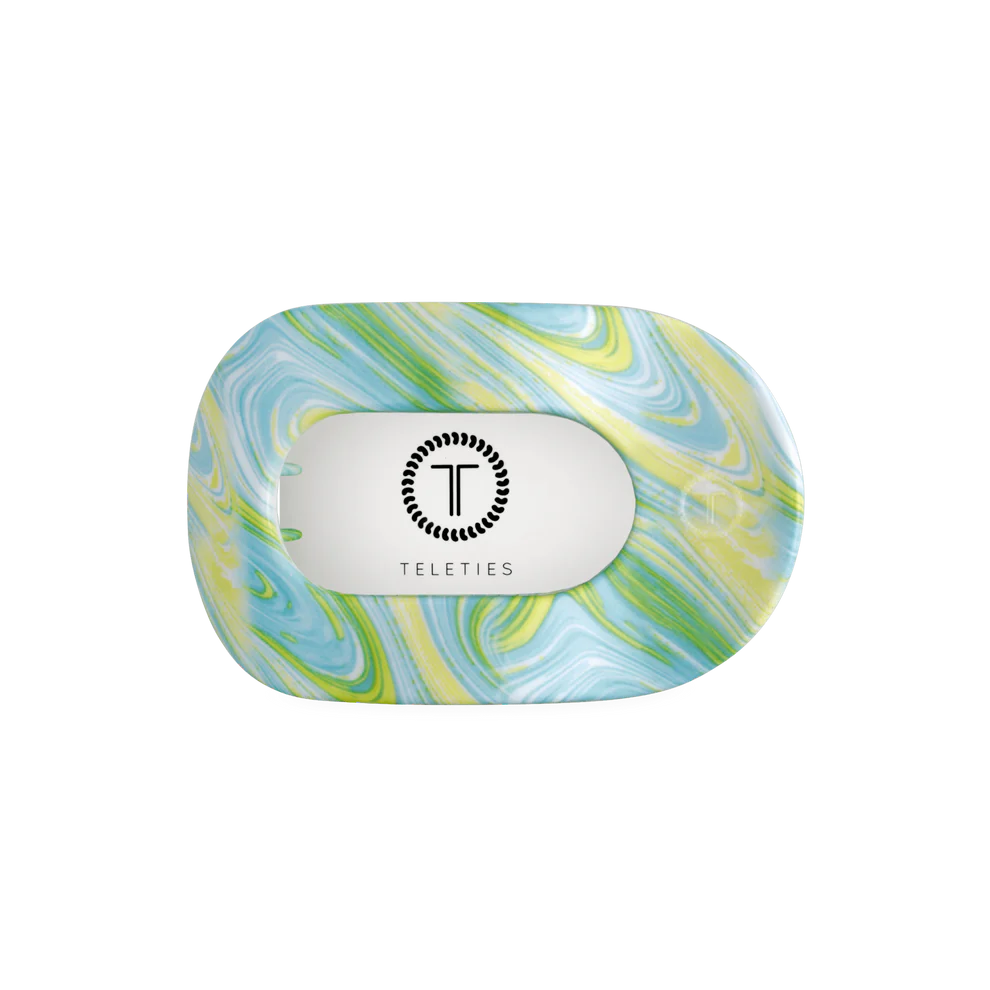 Flat Round Hair Clip in Summer Tie Dye: blue, green, yellow marbled pattern, clear center with black logo. Available in multiple sizes.