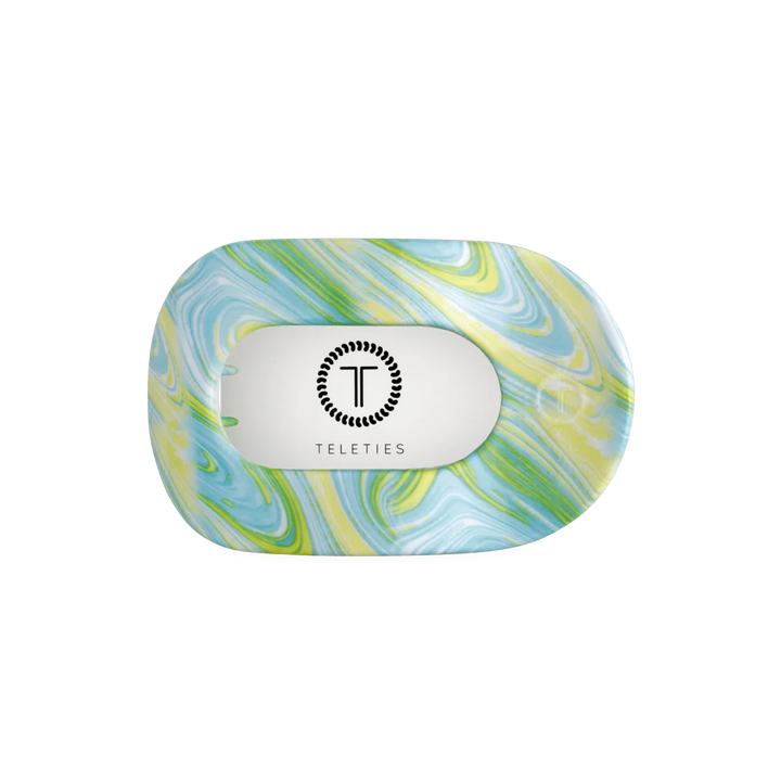 Flat Round Hair Clip in Summer Tie Dye: blue, green, yellow marbled pattern, clear center with black logo. Available in multiple sizes.