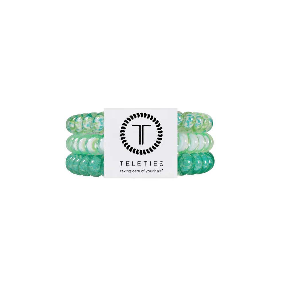 Three green and white TELETIES hair ties, secured by a branded label. Available in small, medium, and large sizes.