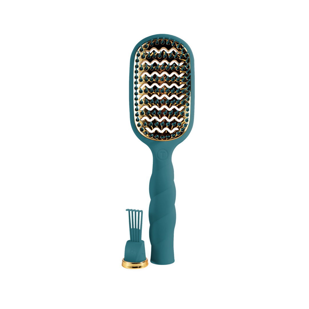 The Vented Hair Brush - Teal With It features a teal and gold wavy design with anti-static bristles for faster blowouts. Available sizes: small, medium, large.