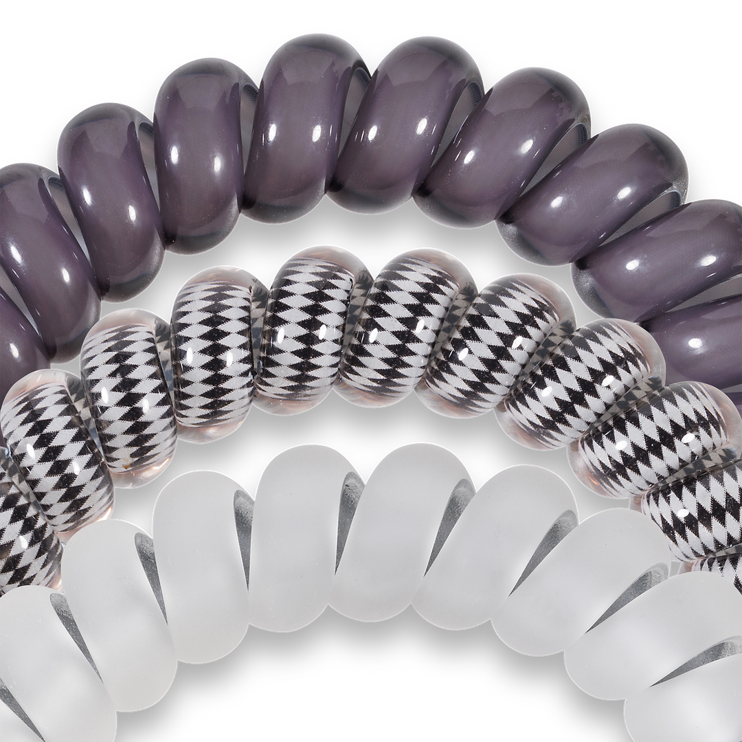 Three large Spiral Hair Coils in assorted colors and patterns, offering a strong grip or wearable as stylish bracelets.