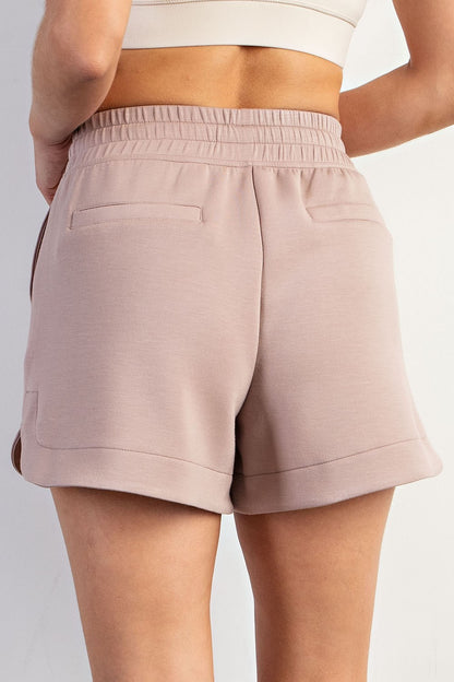 High-waisted, light mauve Modal Scuba Tulip Shorts with elastic waist, two back pockets. Available in sizes XS–XL.