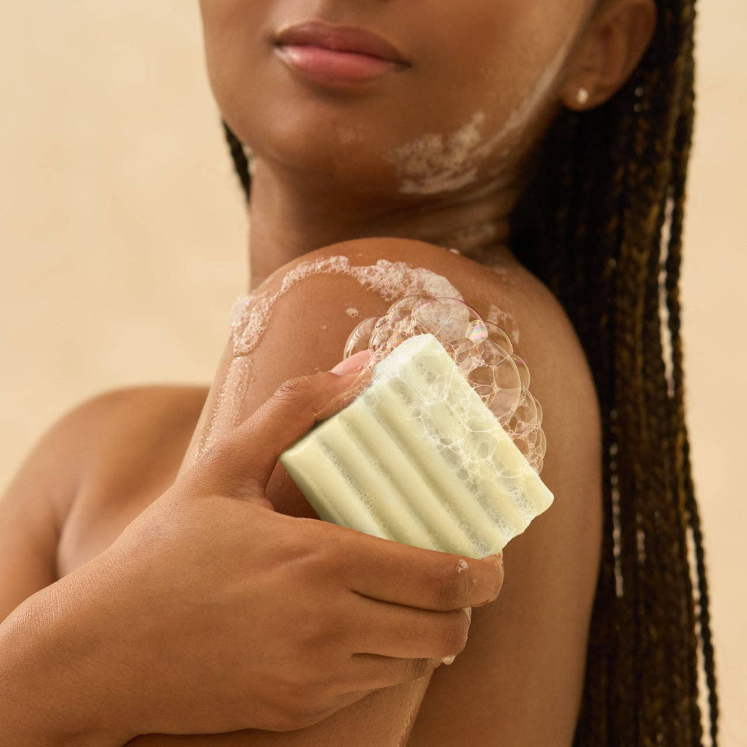 Glycolic Acid Exfoliating Face and Body Wash lathers on skin; available in 6.7 oz and 12 oz sizes for brightening.