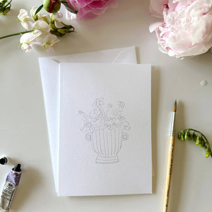 Bouquets paintable watercolor notecard set includes a blank card with a simple vase and flowers sketch on top of white envelopes. Sizes available: standard A2.