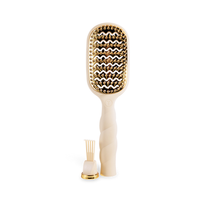 The Vented Hair Brush | Tan features a gold and cream color scheme with a wavy bristle design for optimal airflow during styling. Available in multiple sizes.
