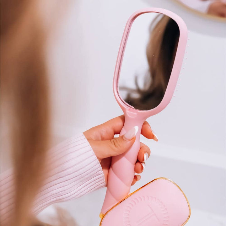 Bubblegum pink Detangler Brush, Medium, with a built-in mirror.