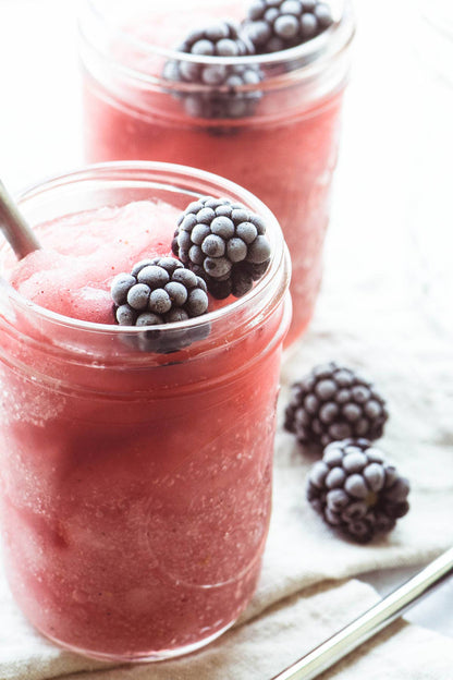 Two glass jars with pink frozen drinks from Wine & Cocktail Slush Mix Bags, available in 8oz and 16oz.