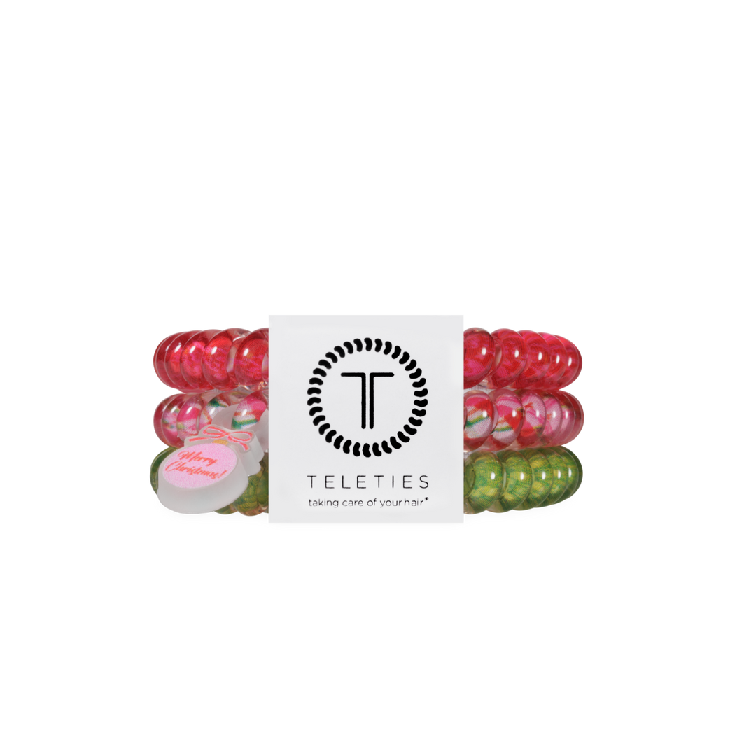 And to All a Good Night, Small: set of three red, pink, and green spiral coil hair ties with a “Merry Christmas” ornament charm.