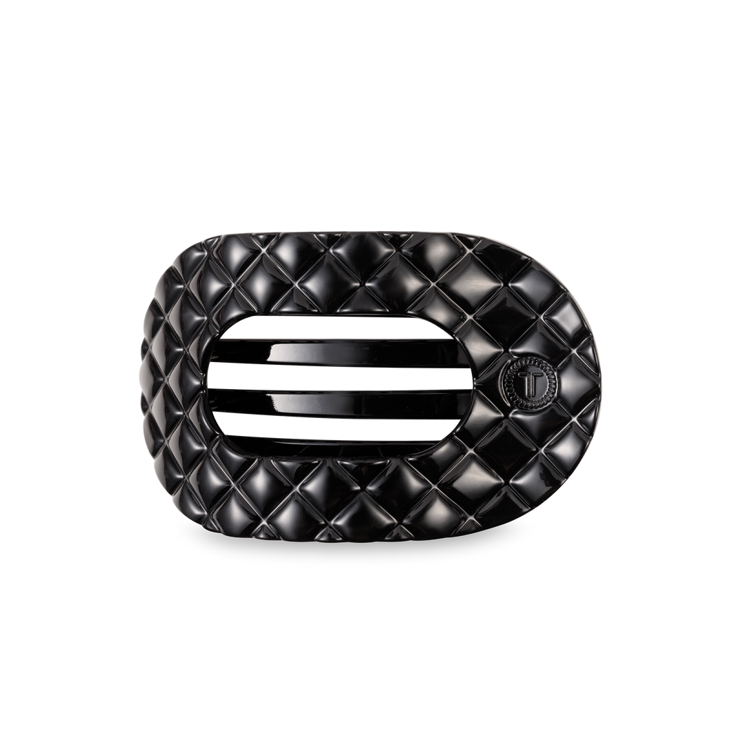 Black oval TELETIES Flat Round Hair Clip with quilted pattern, vent, "T" emblem; available in small, medium, large.