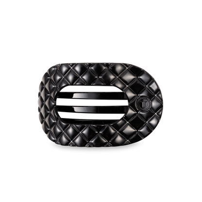 Black oval TELETIES Flat Round Hair Clip with quilted pattern, vent, "T" emblem; available in small, medium, large.
