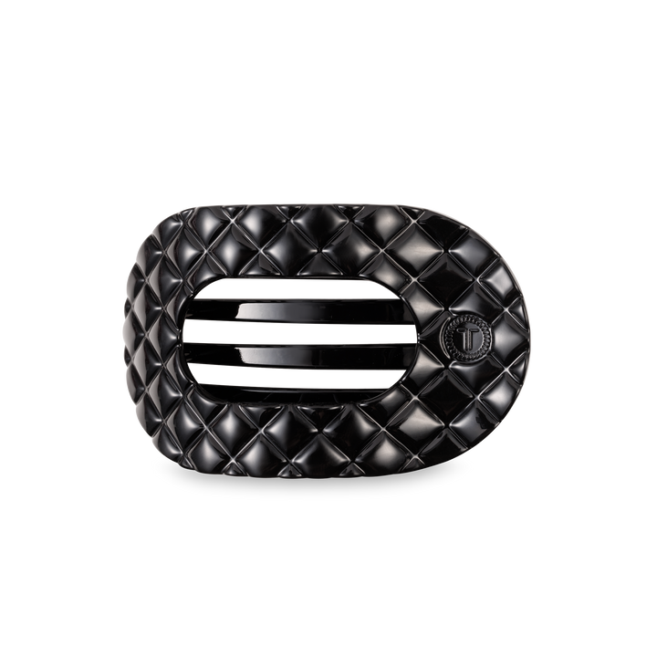 Black oval TELETIES Flat Round Hair Clip with quilted pattern, vent, "T" emblem; available in small, medium, large.