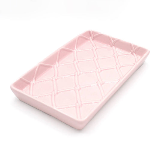 Rectangular light pink ceramic guest towel tray with raised diamond crisscross texture. Available in one size.