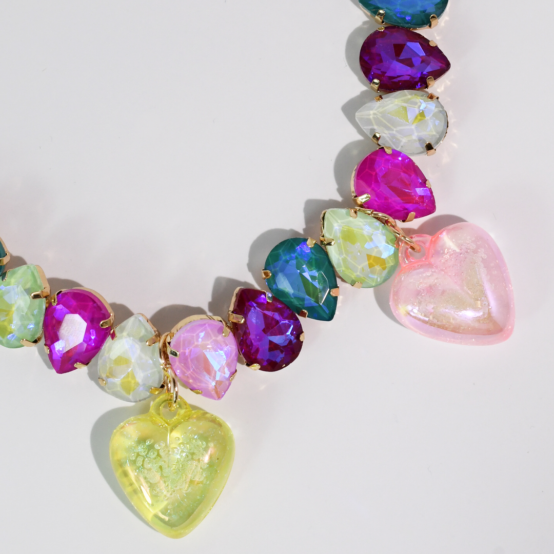 Colorful necklace with faceted teardrop beads and two large heart charms in pink and yellow. Available in S, M, L sizes.