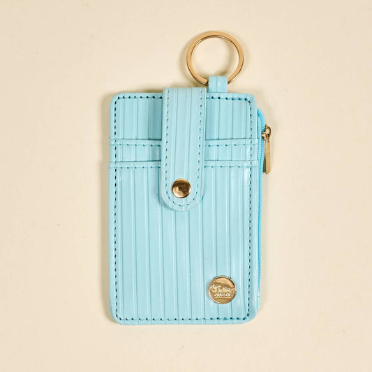 The Ripple Ridge Keychain Wallet–Blue: light blue stripes, gold keyring, snap closure, front pocket, zip coin holder, small gold emblem. Sizes: S/M/L.