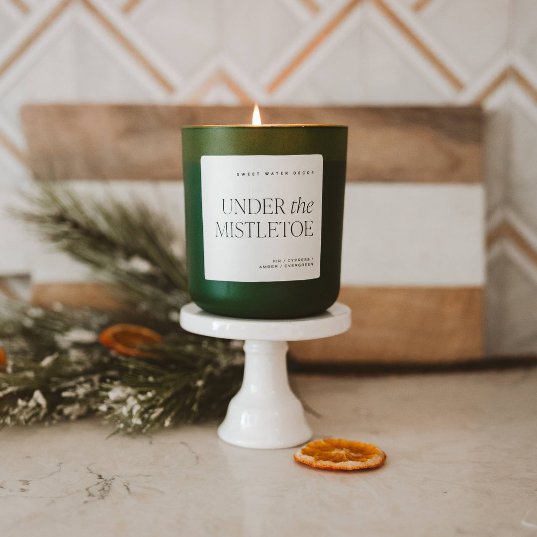 Lit green Under the Mistletoe soy matte candle, 15 oz.