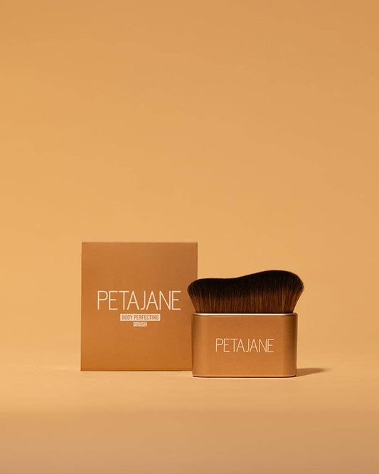 Body Perfecting Brush with dense bristles. Available sizes: standard, travel. Gold handle.