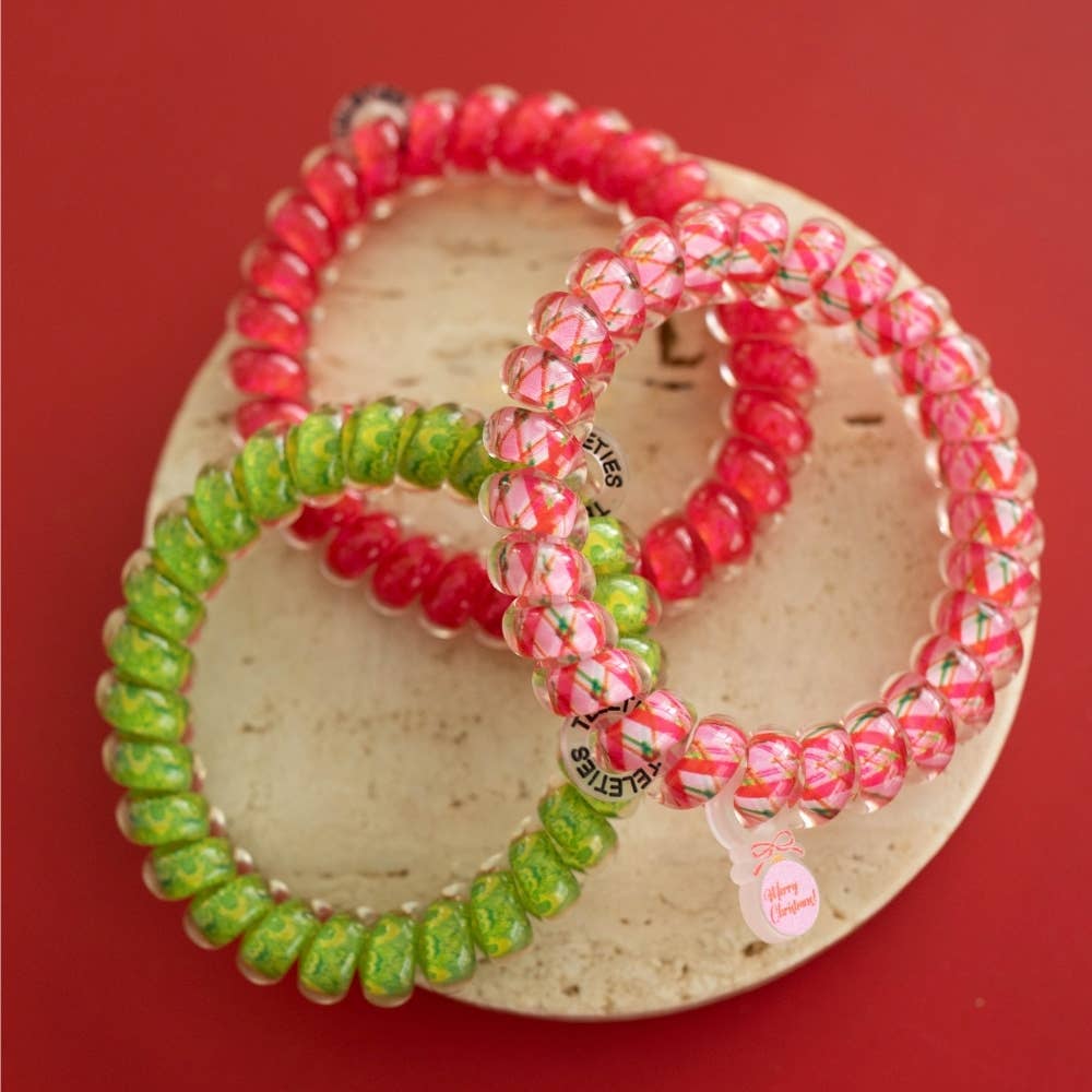 And to All a Good Night hair ties, large size, featuring three red, green, and clear patterned spiral coils with a “Merry Christmas!” tag.