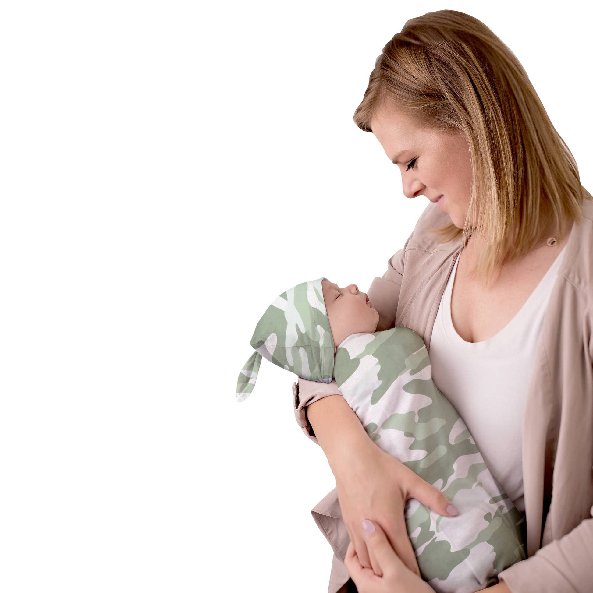 Mother holding baby in camo cocoon sleeper with matching hat.