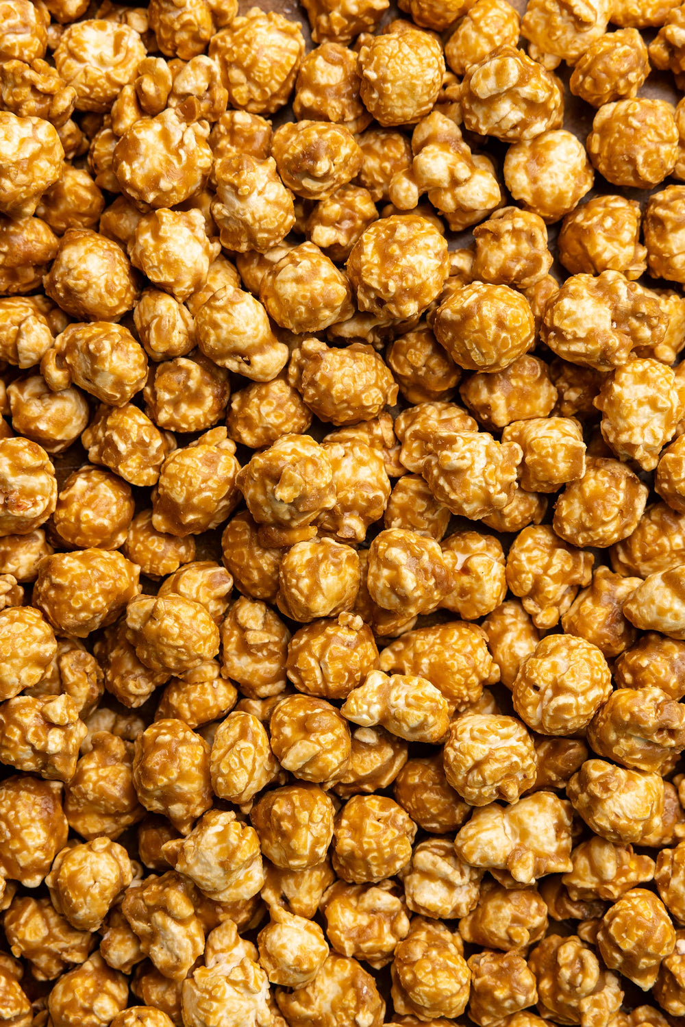 Salted Caramel Snack Bag with golden caramel popcorn clusters, gluten-free. Available in 2oz and 5oz sizes.