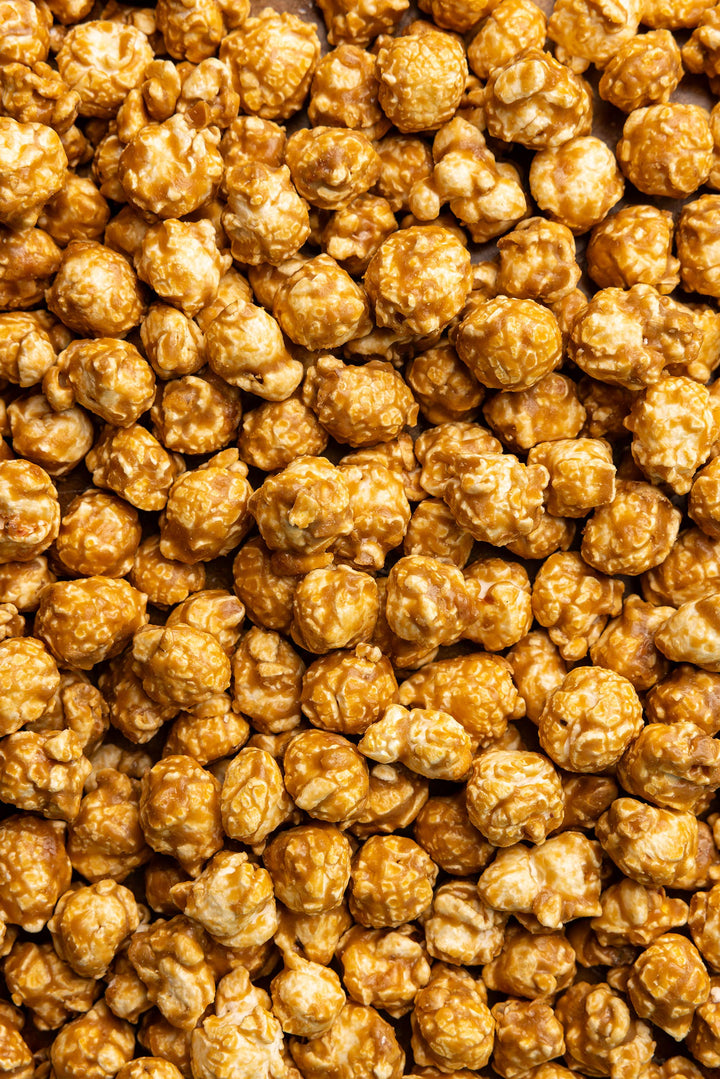 Salted Caramel Snack Bag with golden caramel popcorn clusters, gluten-free. Available in 2oz and 5oz sizes.