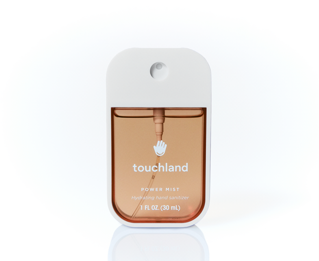 Amber-colored Salted Caramel Power Mist Hand Sanitizer in a white 1 fl oz (30 mL) spray bottle.