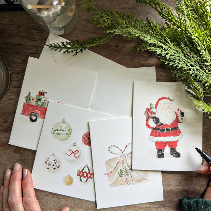 Classic christmas assorted notecard set featuring a watercolor vintage truck with gifts, holiday ornaments, a wrapped gift, and Santa Claus.