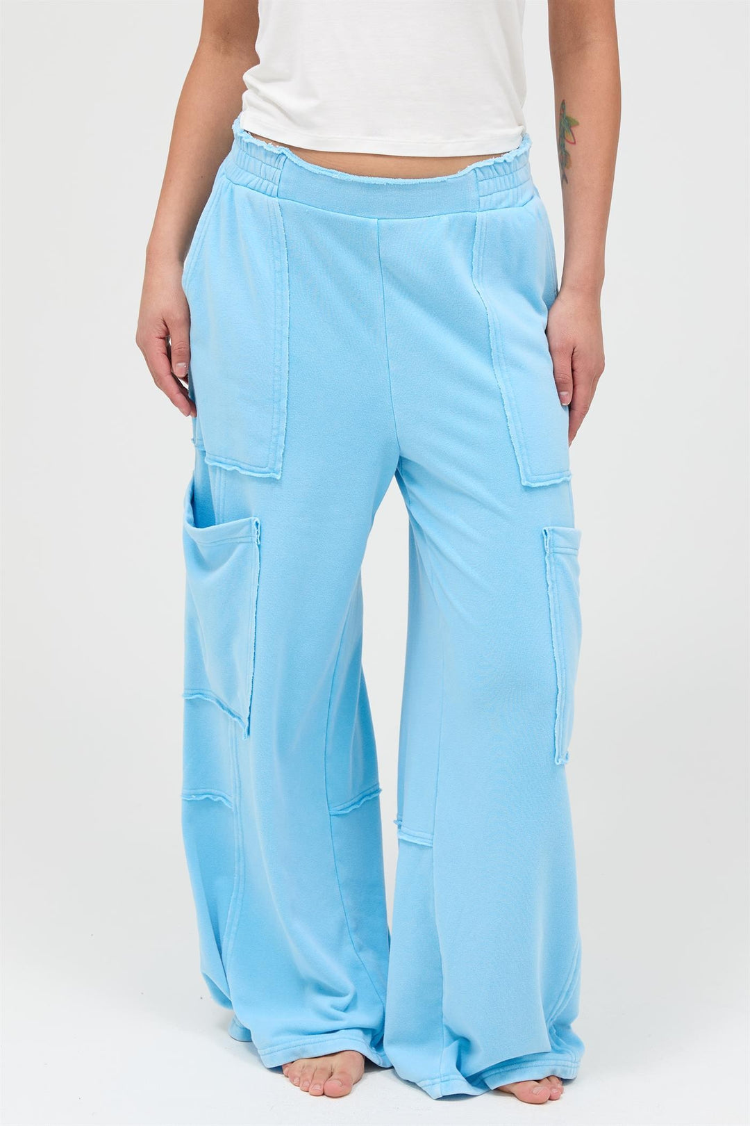 Mineral Wash Wide Leg Cargo Pants in light blue with large patch pockets, visible seams, elastic waistband. Sizes: XS-XL.