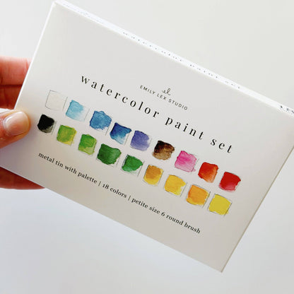 Watercolor paint set with 18 vibrant colors, metal tin, and brush shown. Compact size, suitable for travel.
