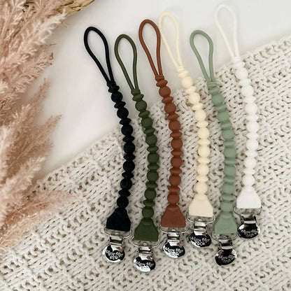 Five Sweetie Strap™ Silicone One-Piece Pacifier Clips in Hero Blue with beaded design. Sizes available: standard.
