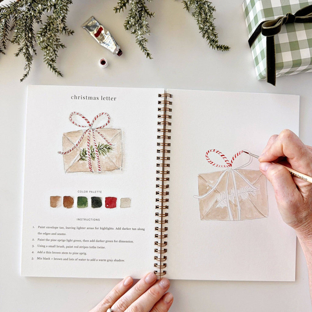 Classic Christmas watercolor workbook featuring step-by-step instructions for painting a red and white striped bow on a gift and decorating a Christmas envelope.