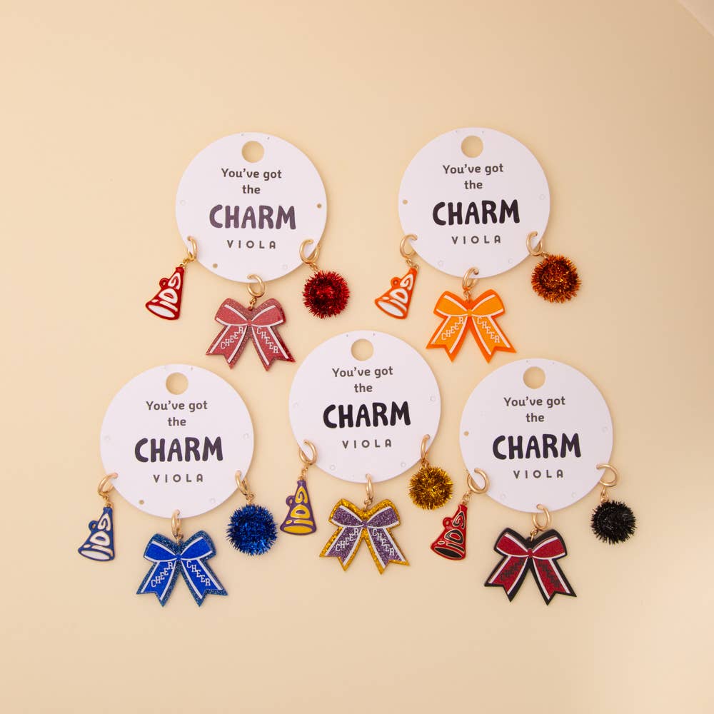 Five charm sets with pom pom, megaphone, and glittered bow. Available sizes: small, medium, large.