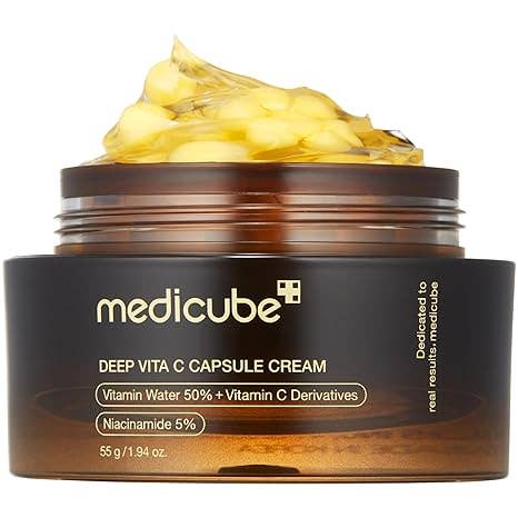 MEDICUBE Deep Vita C Capsule Cream in brown jar with yellow capsules; contains Sea Buckthorn Extract. Sizes: 30ml, 50ml.