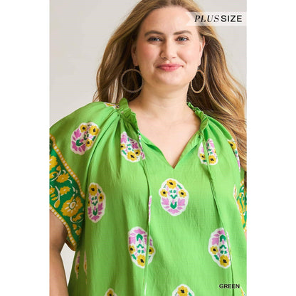 Boho Bloom Border Top: bright green, floral, flutter sleeves, ruffled neckline. Available in plus sizes.