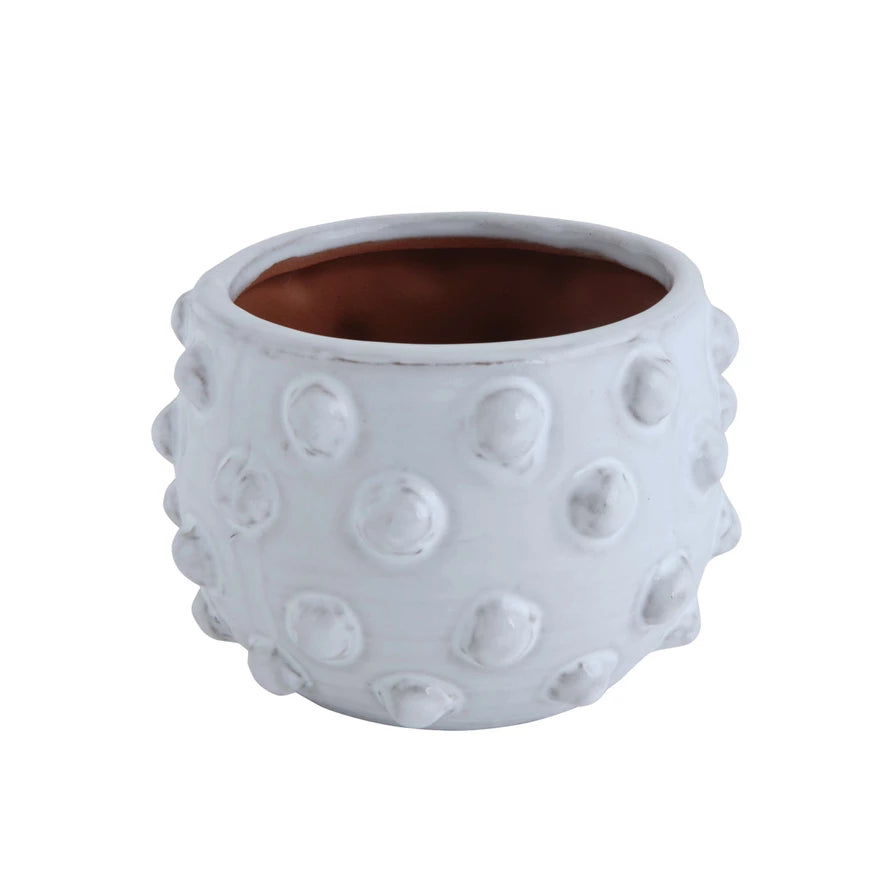 Round white terracotta planter with raised dots, brown interior. Available in multiple sizes. Modern minimalist design.