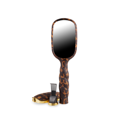 Brown tortoiseshell-patterned folding boar bristle hair brush. Sizes available: small, medium, large.