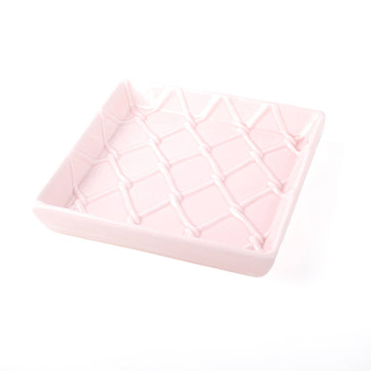 Square light pink ceramic napkin tray with crisscross diamond texture. Available sizes: 6x6 in.