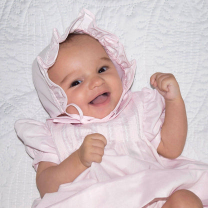Heirloom-quality dress with pintucks and featherstitching, matching bonnet. Available in sizes NB-24M.