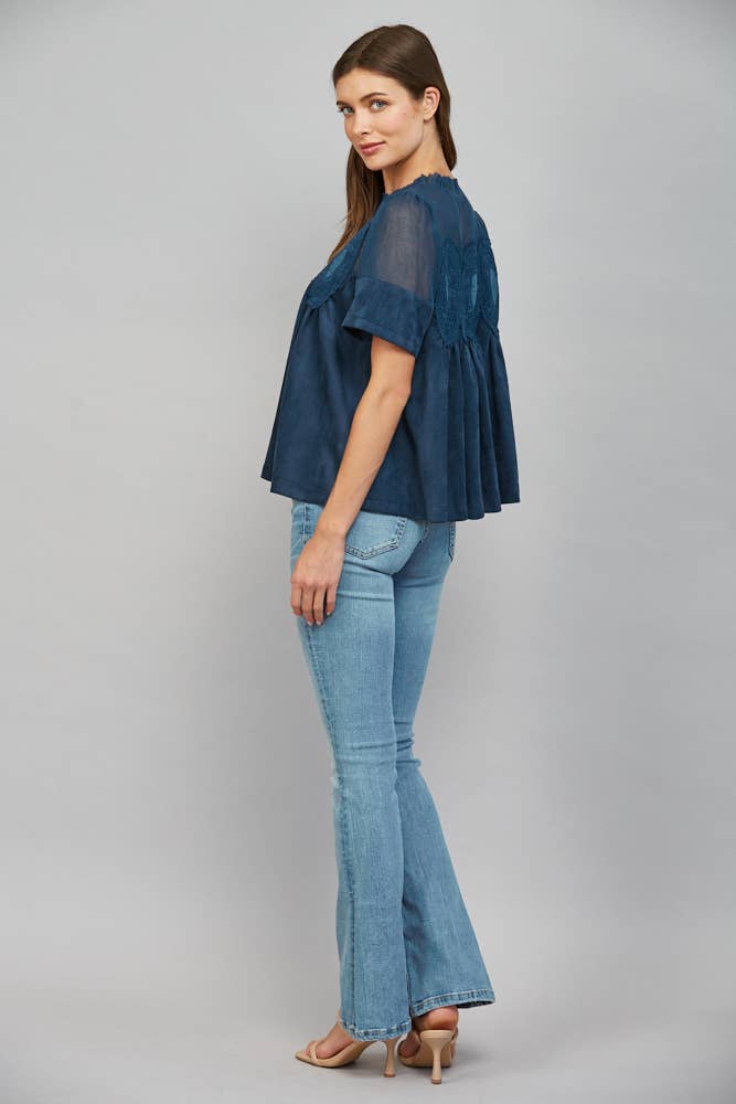 Teal blue short-sleeved faux suede top with sheer mesh upper panel and lace appliqué, size M.