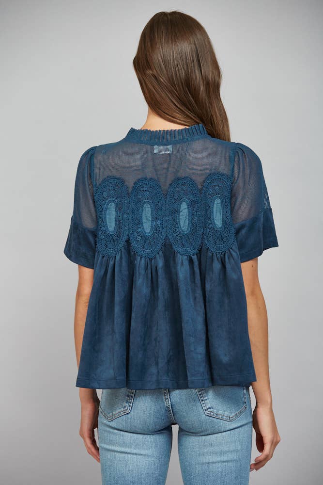 Teal blue short-sleeved top, size M, featuring a sheer mesh upper panel with lace applique and a faux suede lower section.