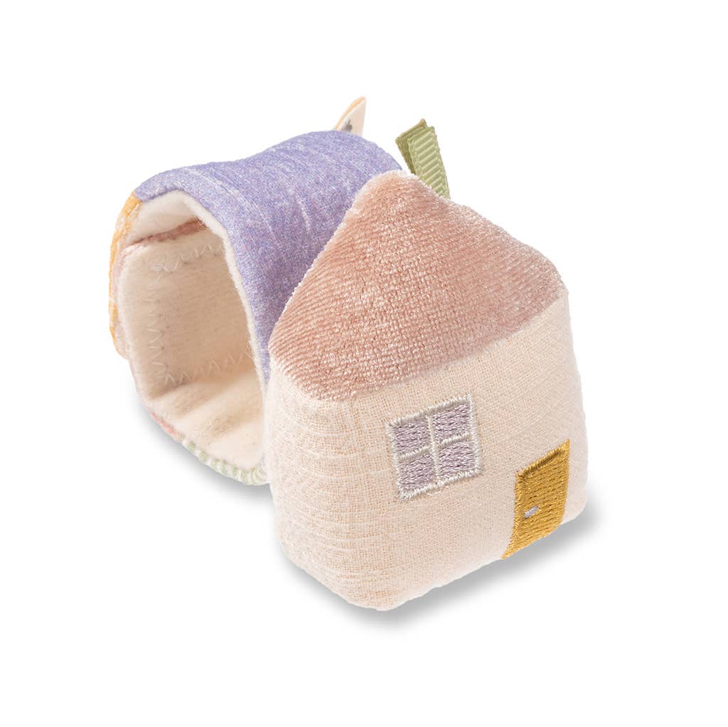 A Itzy Bitzy Wrist Rattle: Cottage shaped like a house, with a blue roof and cream walls, featuring embroidered windows and door. The natural cotton fabric is textured and the toy is designed to be soft and cuddly.