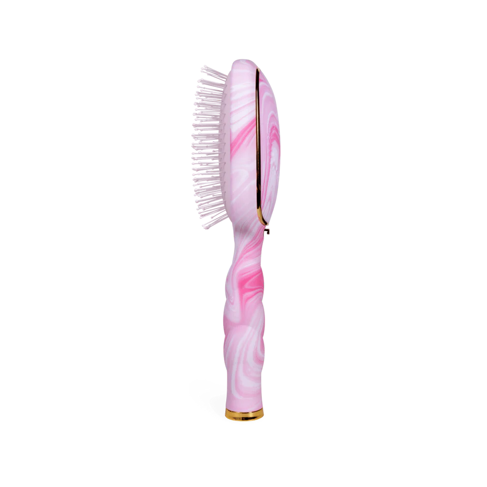 Pink and white marbled detangler brush with gold accents, soft bristles, and curved handle. Available in medium size.