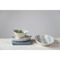 White ceramic bowls and plates with blue leaf patterns. Sizes available: small, medium, large.